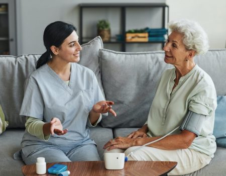 young-nurse-talking-to-senior-woman-in-retirement-home.jpg